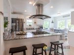 The kitchen offers stainless steel appliances, with a fully stocked kitchen.